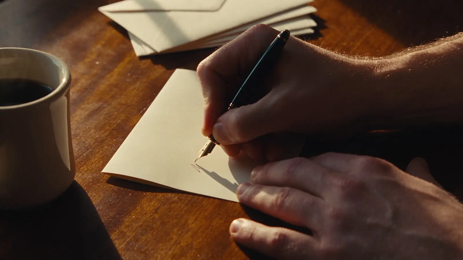 Hands writing a handwritten note